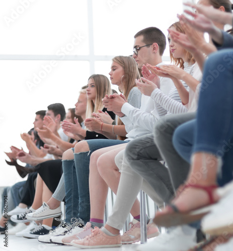 background image of young people applauding in the conference room