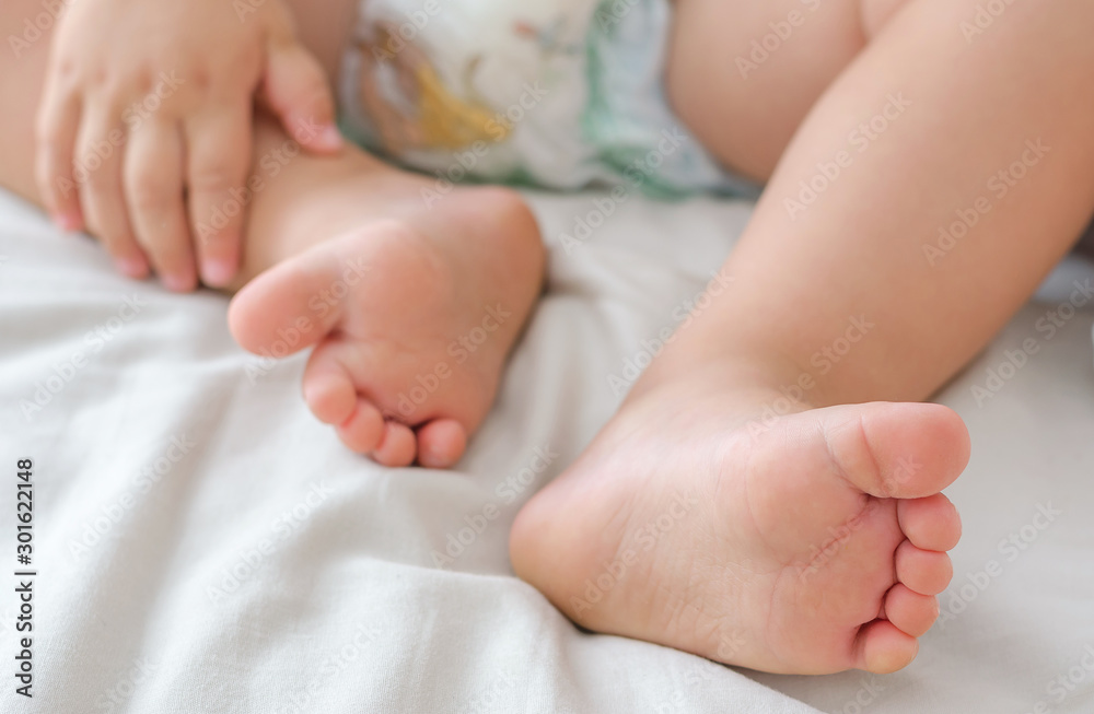 Legs of a two year old baby. The concept of healthy children's feet, legs. Soft focus, background.