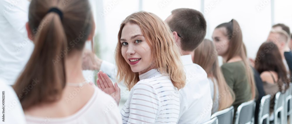 close up. young woman sitting in a row with her associates.