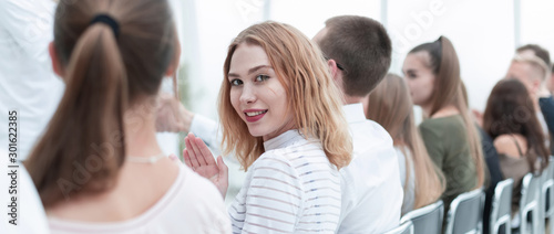 close up. young woman sitting in a row with her associates.