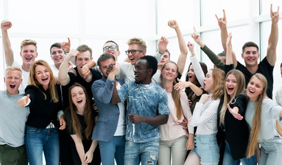 team of happy young people showing their success