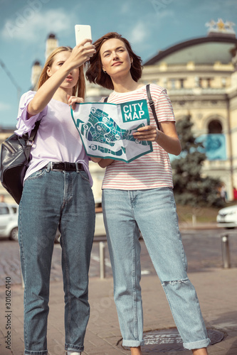 Cheerful young females walking around the city © Viacheslav Yakobchuk