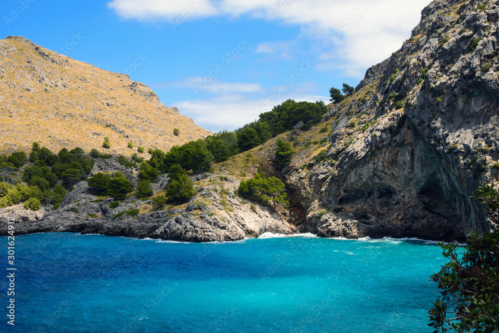 Beautiful famous bay of Sa Calobra on the island of Mallorca, Spain. Turquoise sea, rocks and pines. Travel to the Balearic Islands.