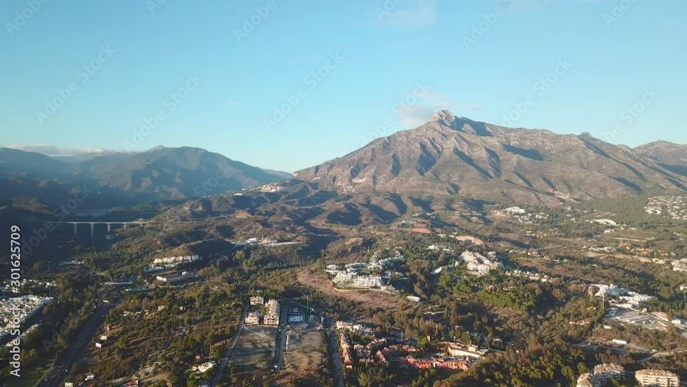 Panoramic aerial view of Marbella. View of La Concha Mountain . Beautiful Andalusian House Urbanisation Architecture and highway A7. Golden Hour, warm light, beautiful colours at sunset. Panoramic aerial view of Marbella. View of La Concha Mountain . Beautiful Andalusian House Urbanisation Architecture and highway A7. Golden Hour, warm light, beautiful colours at sunset.