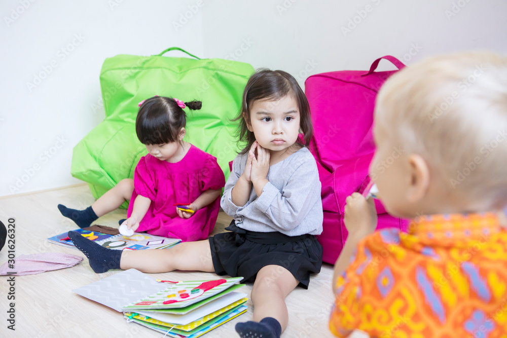 Group of little kids learning in the kindergarten Group of little kids learning in the kindergarten