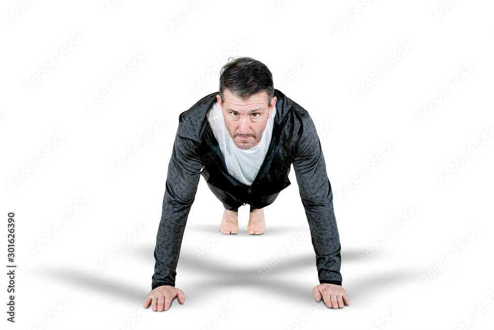 Handsome man looking at camera while doing push-up Handsome man looking at camera while doing push-up