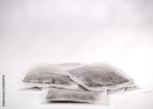 Tea bags resting on a white backdrop