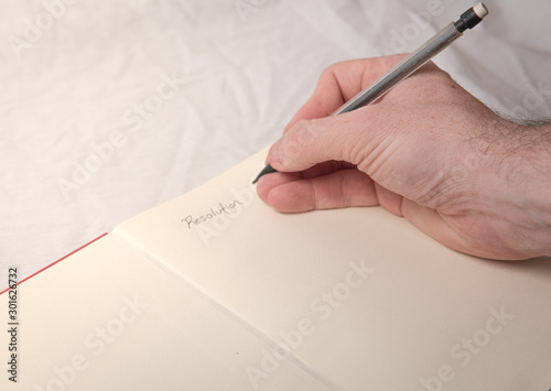 A man writing down new years resolutions