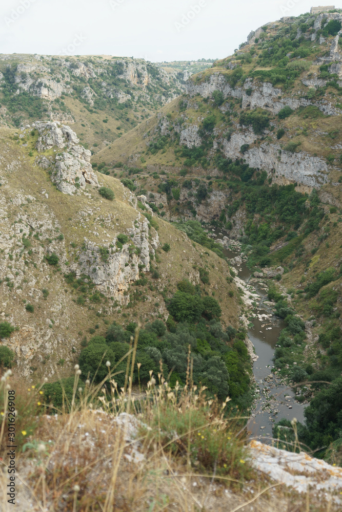the river that flows between the hills near Matera, Italy