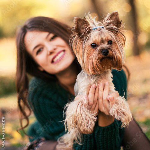 Beautiful woman playing with dog in the park