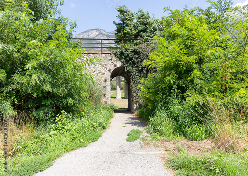 a rural path underneath the railway next to Chatillon, Aosta Valley, Italy