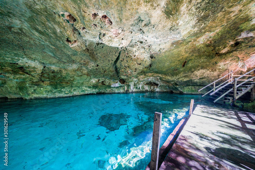 Steps to the Cenote dos ojos, firt eye, turquoise water and cave, Tulum, Quintana Roo, Mexico