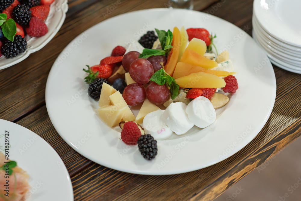 Raw fresh organic fruit and cheese plate Raw fresh organic fruit and cheese plate