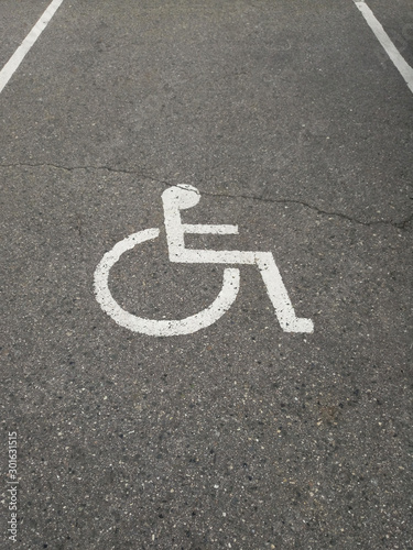 disabled person sign on asphalt