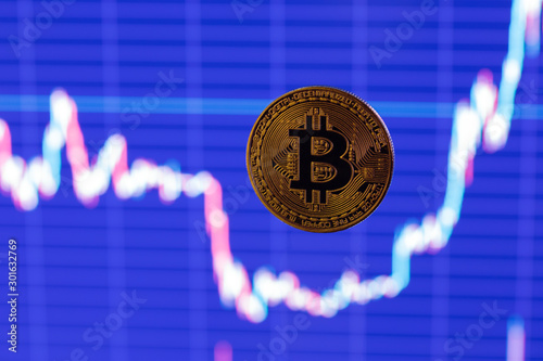 bitcoin shiner flying over blurry dark blue exchange graphic chart photo