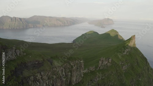 Aerial drone video flying over majestic Alaberg cliffs on Mykines island, Faroe Islands. UHD 4k video photo