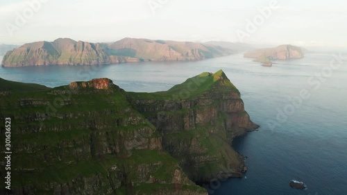 Aerial drone video flying over majestic Alaberg cliffs on Mykines island, Faroe Islands. UHD 4k video photo