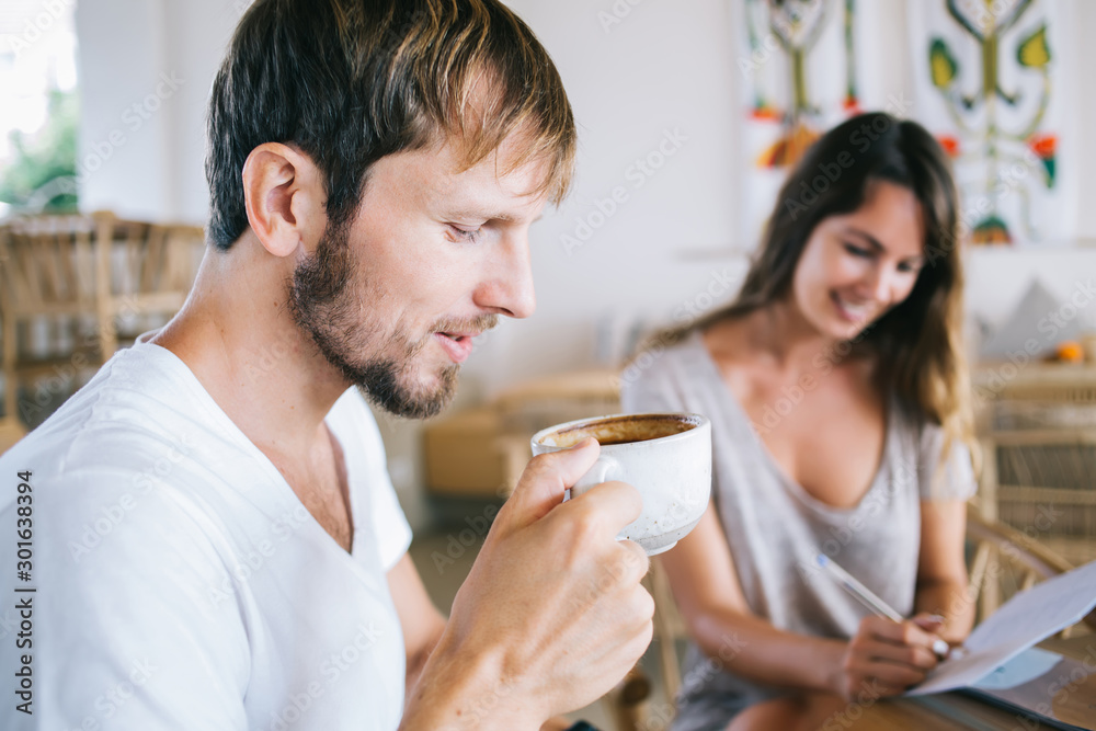 Young man drinking coffee at home