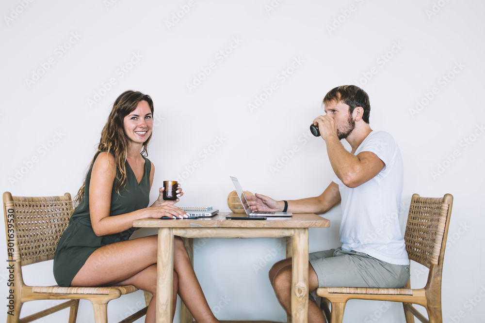 Adult coworkers conversing at cafe