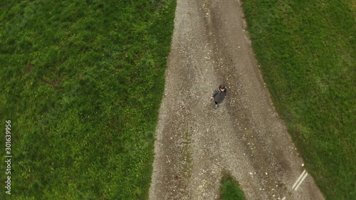 Woman at the crossroads. Symbol of choice.  Aerial shot from the drone.4K