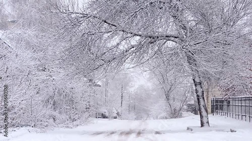 Snowfall in winter in the city, soft snowy christmas morning with falling snow