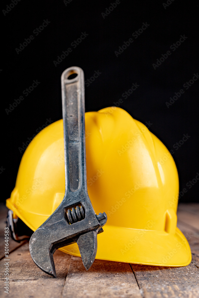 Protective helmet and wrench. Work accessories for production workers.