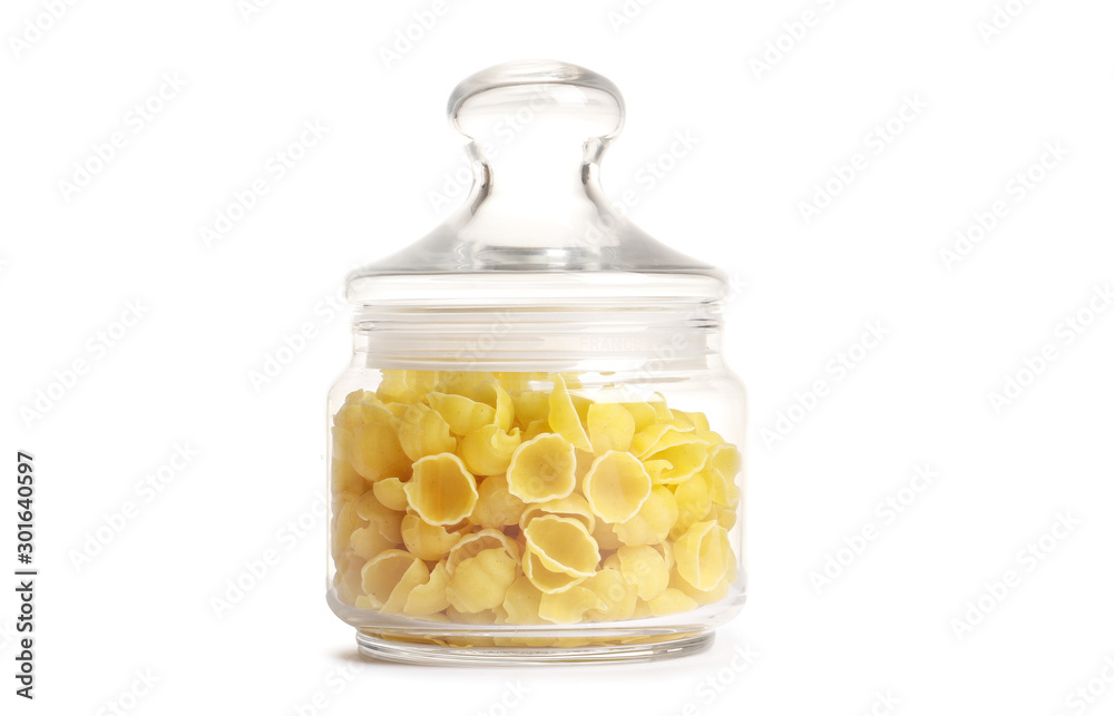 Raw pasta in a glass jar isolated on a white background. Raw pasta in a glass jar isolated on a white background.