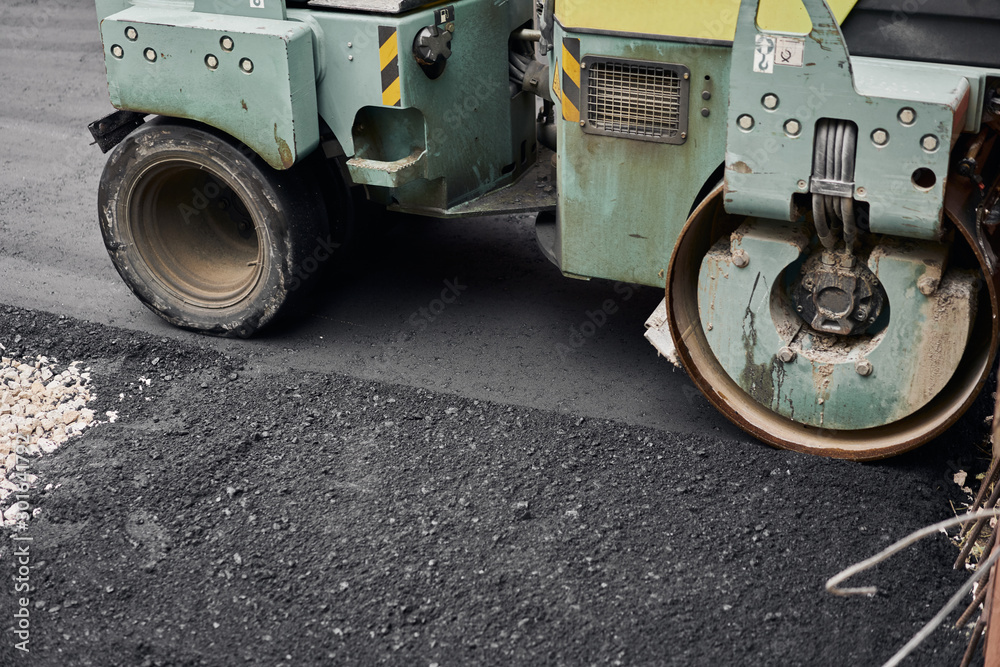 Asphalt Compactors is carrying out road repair work. Laying new asphalt. Large heavy machinery. Construction of a new asphalt road. Asphalt Compactors is carrying out road repair work. Laying new asphalt. Large heavy machinery. Construction of a new asphalt road.