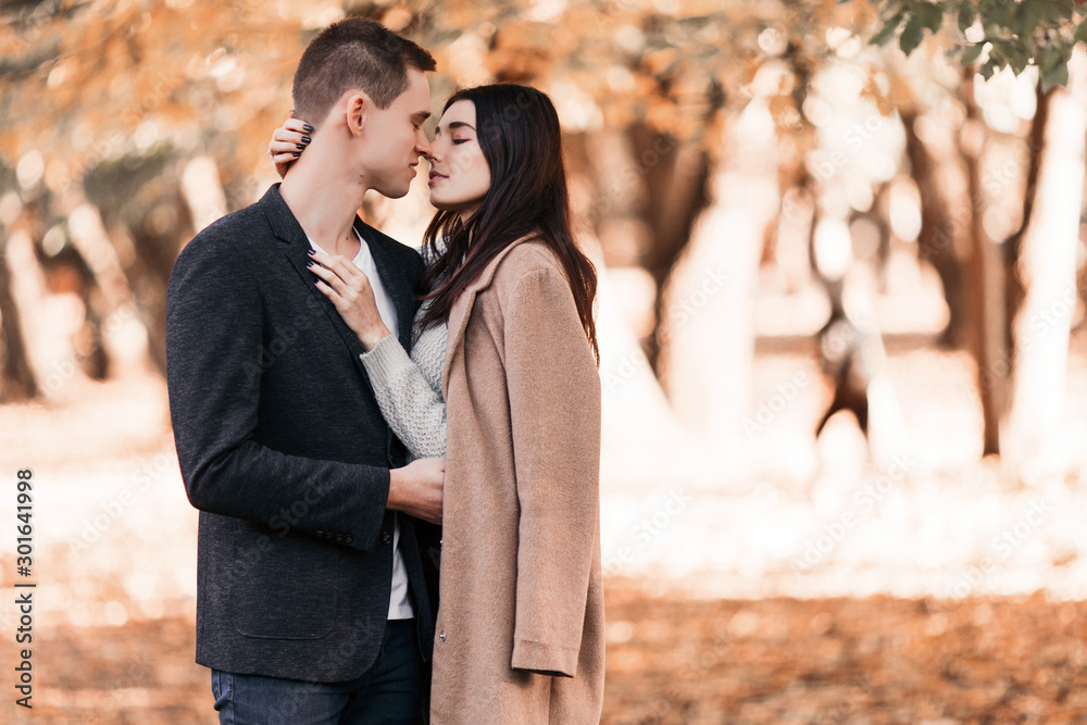 Beautiful young couple walking in autumn park. Beautiful young couple walking in autumn park.