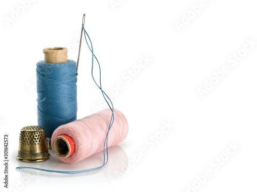 Sewing threads of blue and pink colors