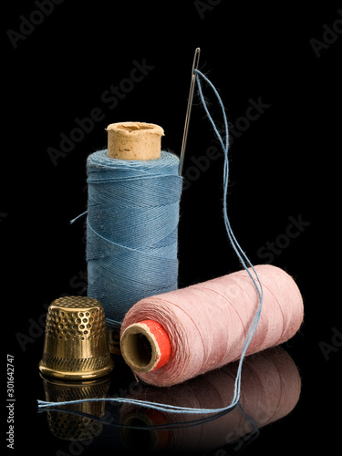 Sewing threads of blue and pink colors