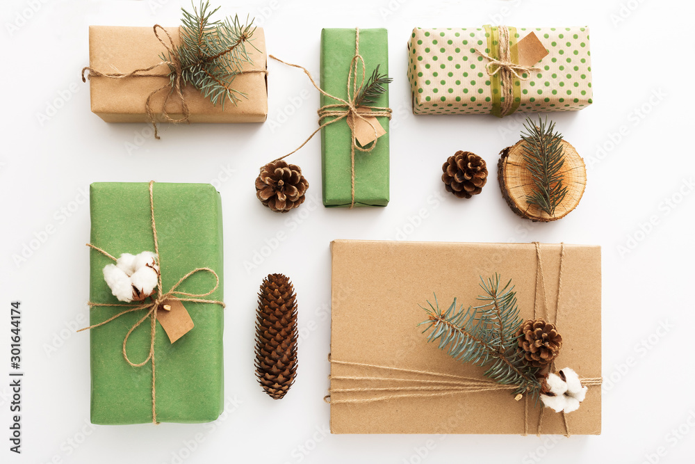 Christmas composition made of pine cones, brunches, tree rings, crafted gifts with no plastic on white table. Christmas, Xmas, winter, new year, Zero waste concept.Top view, copy space, flat lay. Christmas composition made of pine cones, brunches, tree rings, crafted gifts with no plastic on white table. Christmas, Xmas, winter, new year, Zero waste concept.Top view, copy space, flat lay.
