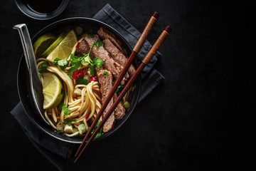 Tasty asian classic soup with noodles and meat