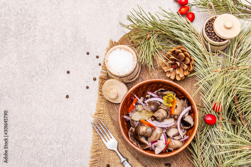 Pickled (fermented) mushrooms. Traditional New Year (Christmas) snack. Festive table cutlery setting