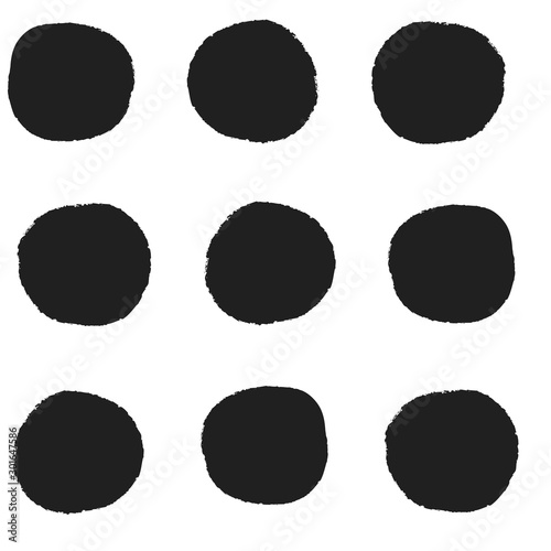 Seamless repeat pattern with big bold black irregular hand-drawn polka dots in rows on a white background