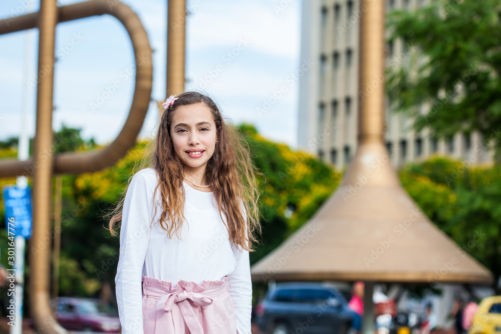 Beautiful young girl at the Jairo Varela Square in the city of Cali in Colombia