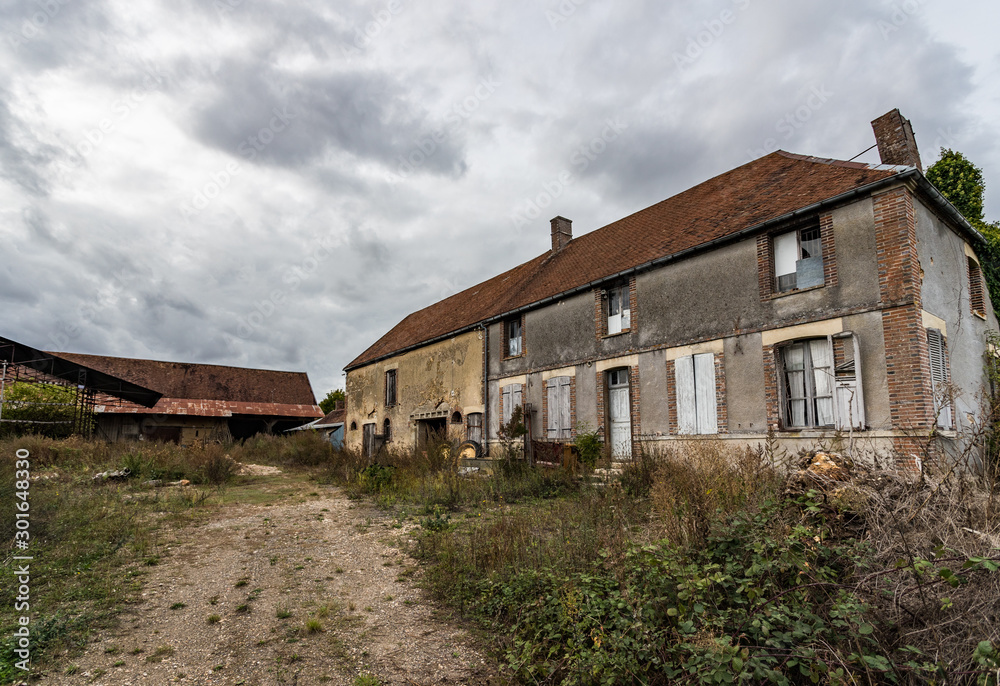 An old abandoned  and decaying farmhouse in the rural french countryside