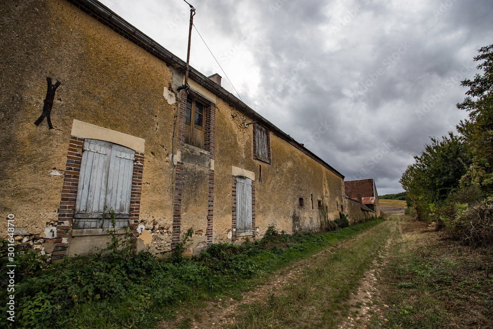 An old abandoned and decaying farmhouse in the rural french countryside An old abandoned and decaying farmhouse in the rural french countryside