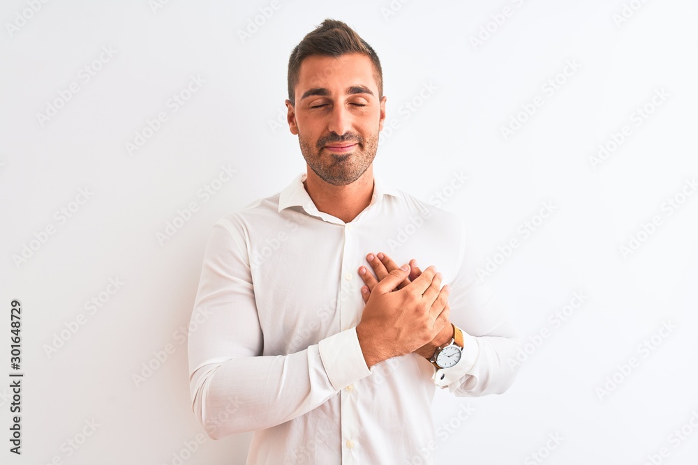 Young handsome business man wearing elegant shirt over isolated background smiling with hands on chest with closed eyes and grateful gesture on face. Health concept. Young handsome business man wearing elegant shirt over isolated background smiling with hands on chest with closed eyes and grateful gesture on face. Health concept.