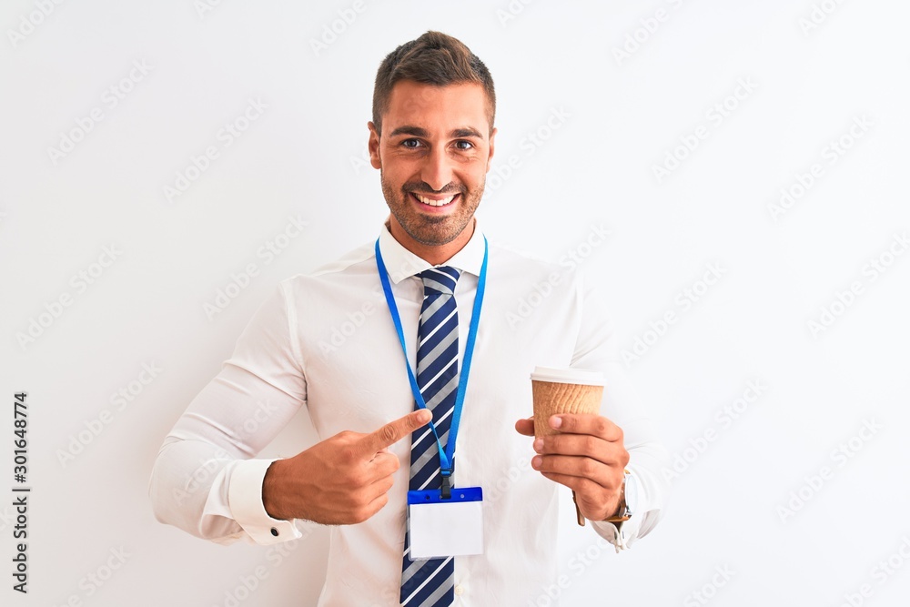 Young handsome business man wearing id pass and drinking coffee over isolated background very happy pointing with hand and finger Young handsome business man wearing id pass and drinking coffee over isolated background very happy pointing with hand and finger