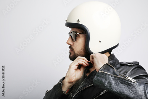 Close-up portrait of biker guy with white helmet. Isolated.