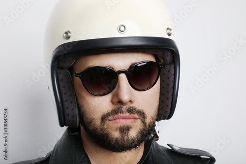 Close-up portrait of biker with white helmet. Isolated. © face_reader_img