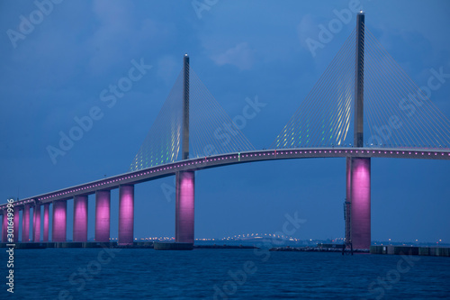 Closeup of the iconic Sunshine Skyway Bridge spanning the wide mouth of beautiful Tampa Bay in central Florida lit up in pink LED lights to commemorate Breast Cancer Awareness Month. © Michael O'Keene