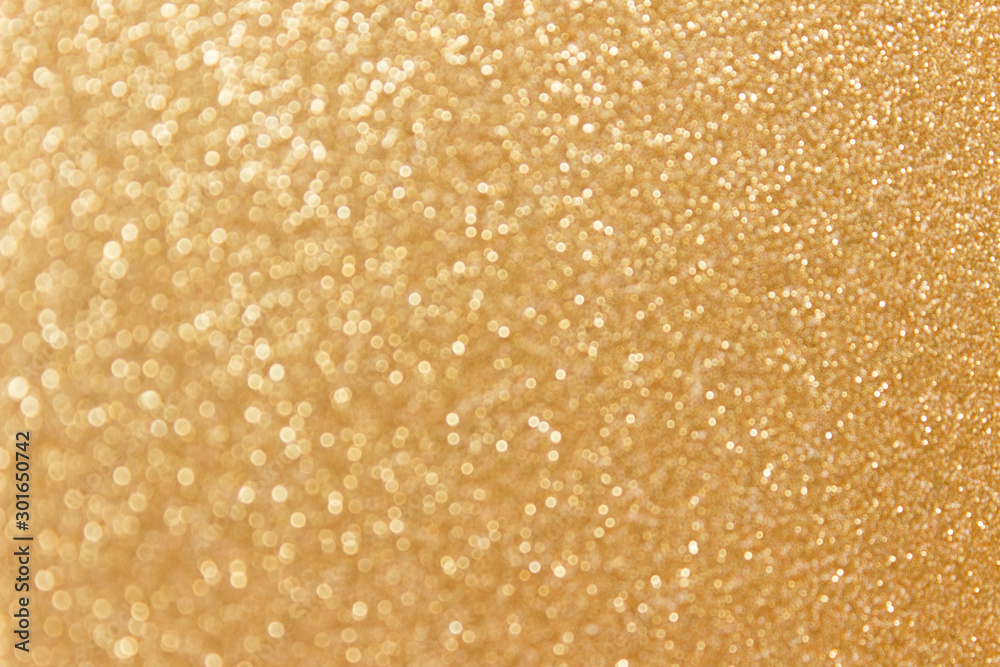 Festive golden glitter sparkling background with defocused bokeh effect. Festive golden glitter sparkling background with defocused bokeh effect.