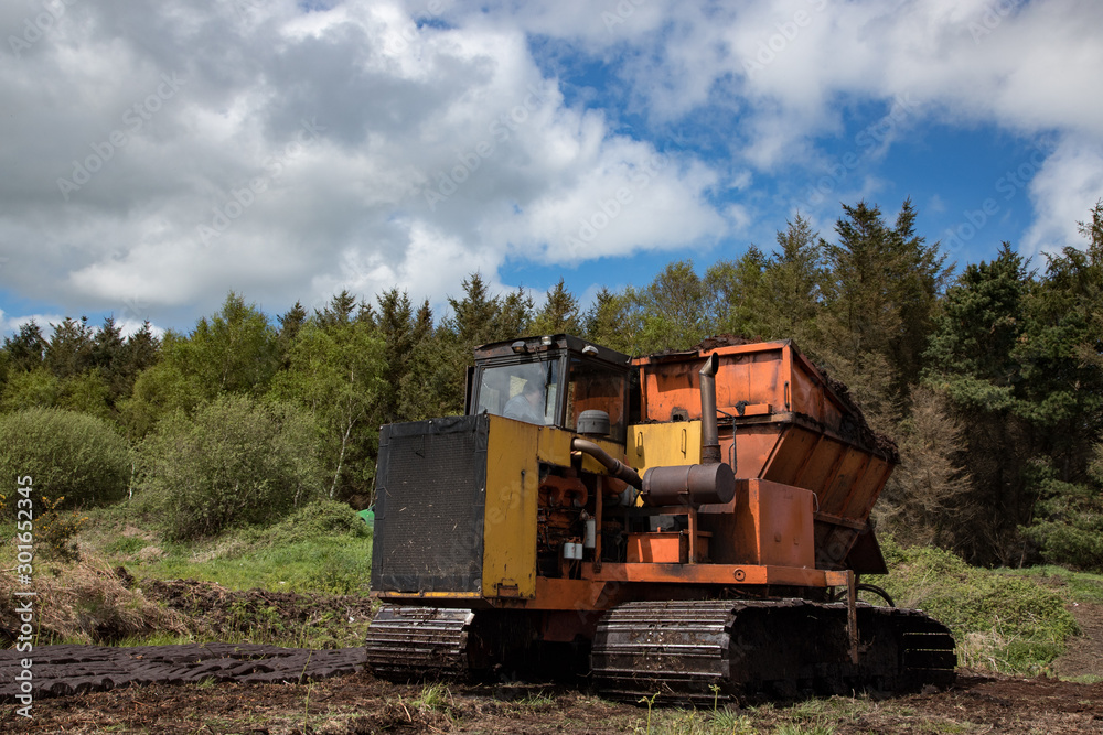 Heavy machinery used for cultivating peat bog in the Irish countryside Heavy machinery used for cultivating peat bog in the Irish countryside