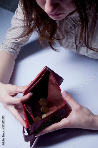 Poverty and pain concept. Young frustrated and desperate Woman counting small money