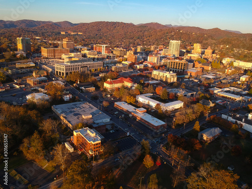 Downtown Asheville, North Carolina. Aerial drone view of the city in the Blue Ridge Mountains during Autumn / Fall Season.  Architecture, Buildings, Cityscape, Skyline, and forests. Southeast U.S.