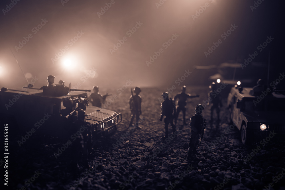 Fototapeta premium Military patrol car on sunset background. Army war concept. Silhouette of armored vehicle with soldiers ready to attack. Artwork decoration. Selective focus