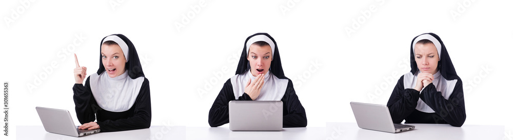 Nun working on laptop - religious concept Nun working on laptop - religious concept