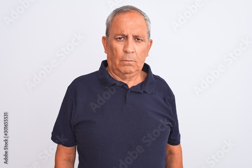 Senior grey-haired man wearing black casual polo standing over isolated white background depressed and worry for distress, crying angry and afraid. Sad expression.
